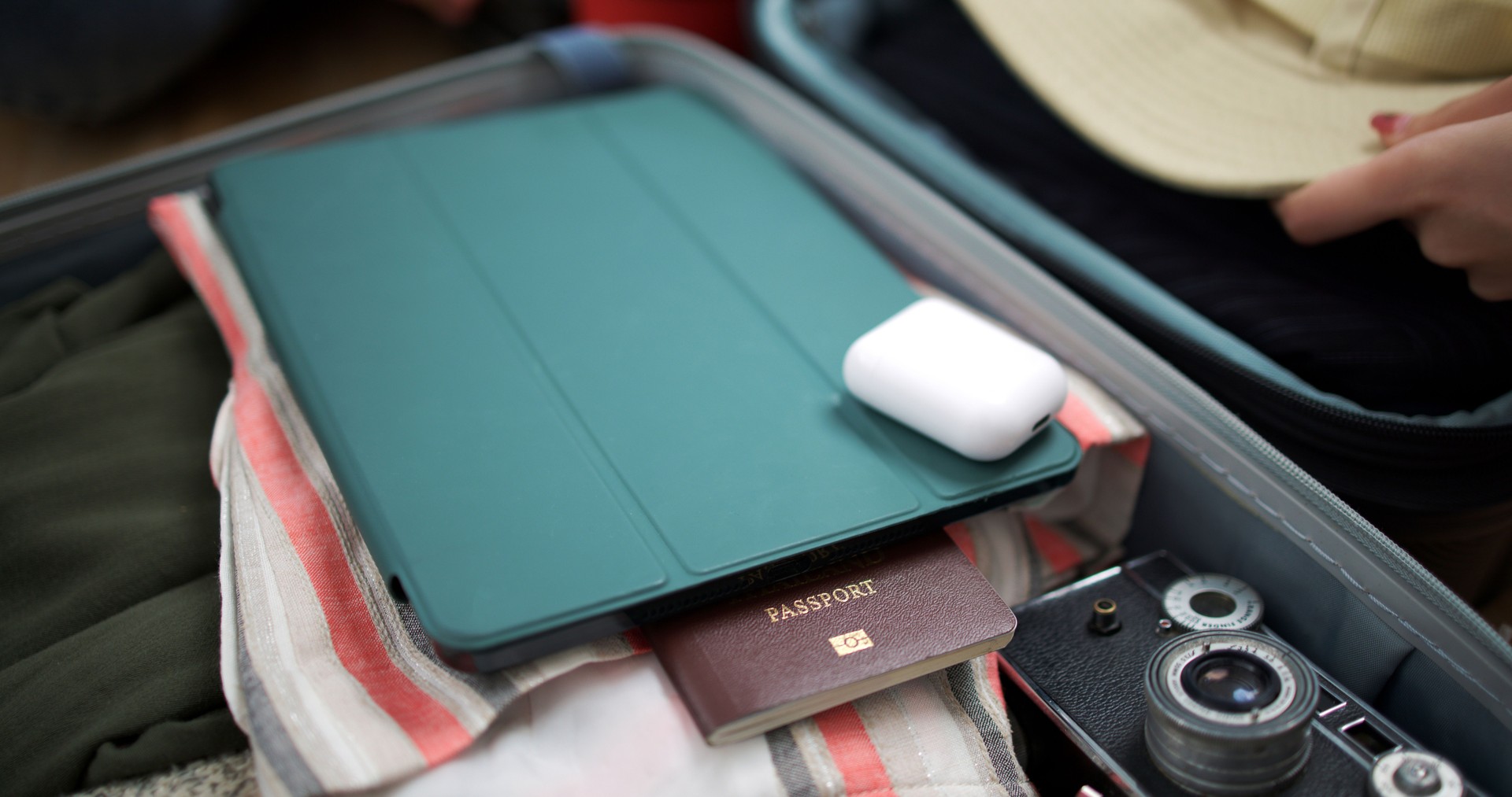 Digital boarding app on smart phone with clothes and belongings in suitcases