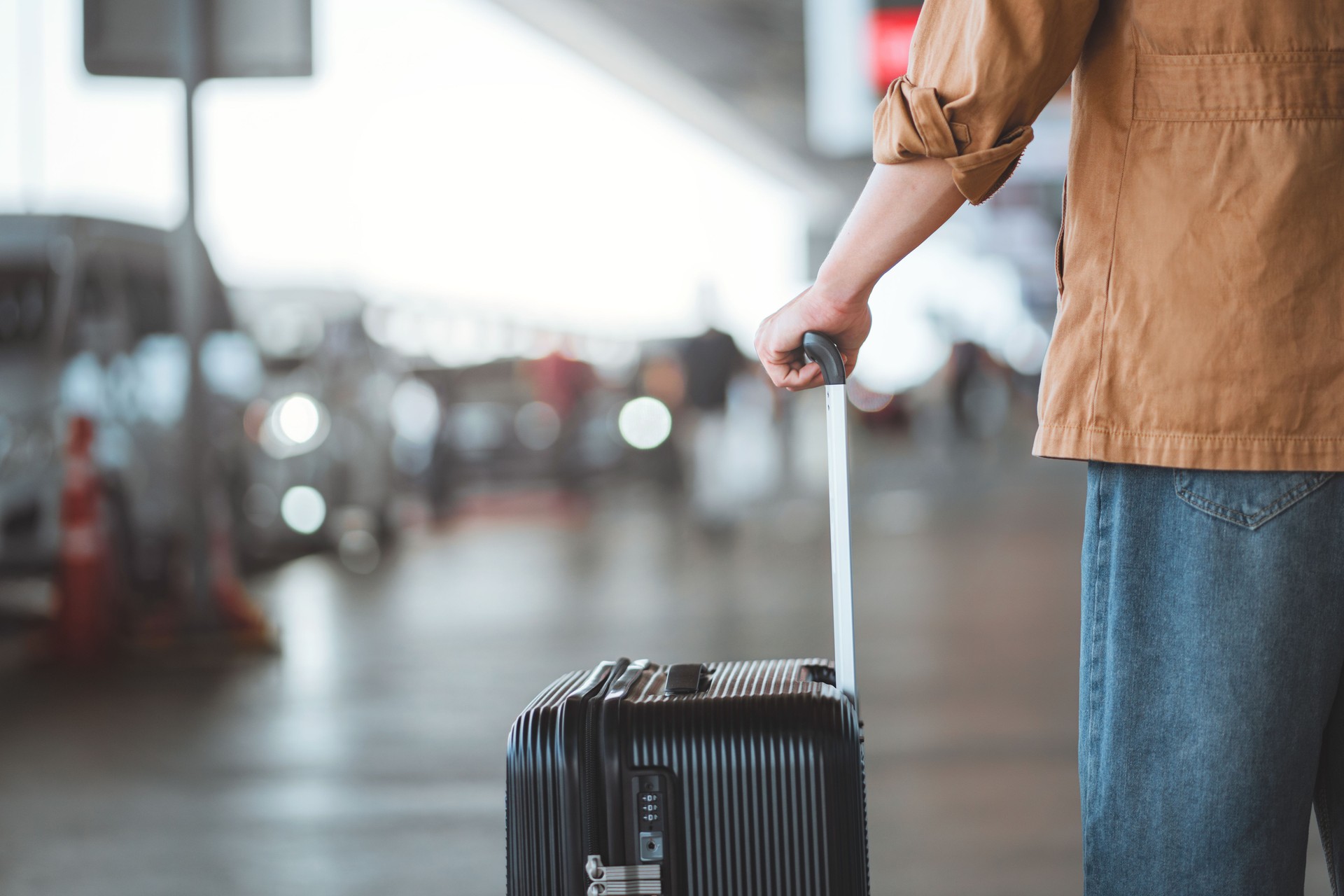 Local driver greeting backpacker at the airport for a Welcome Pickups transfer